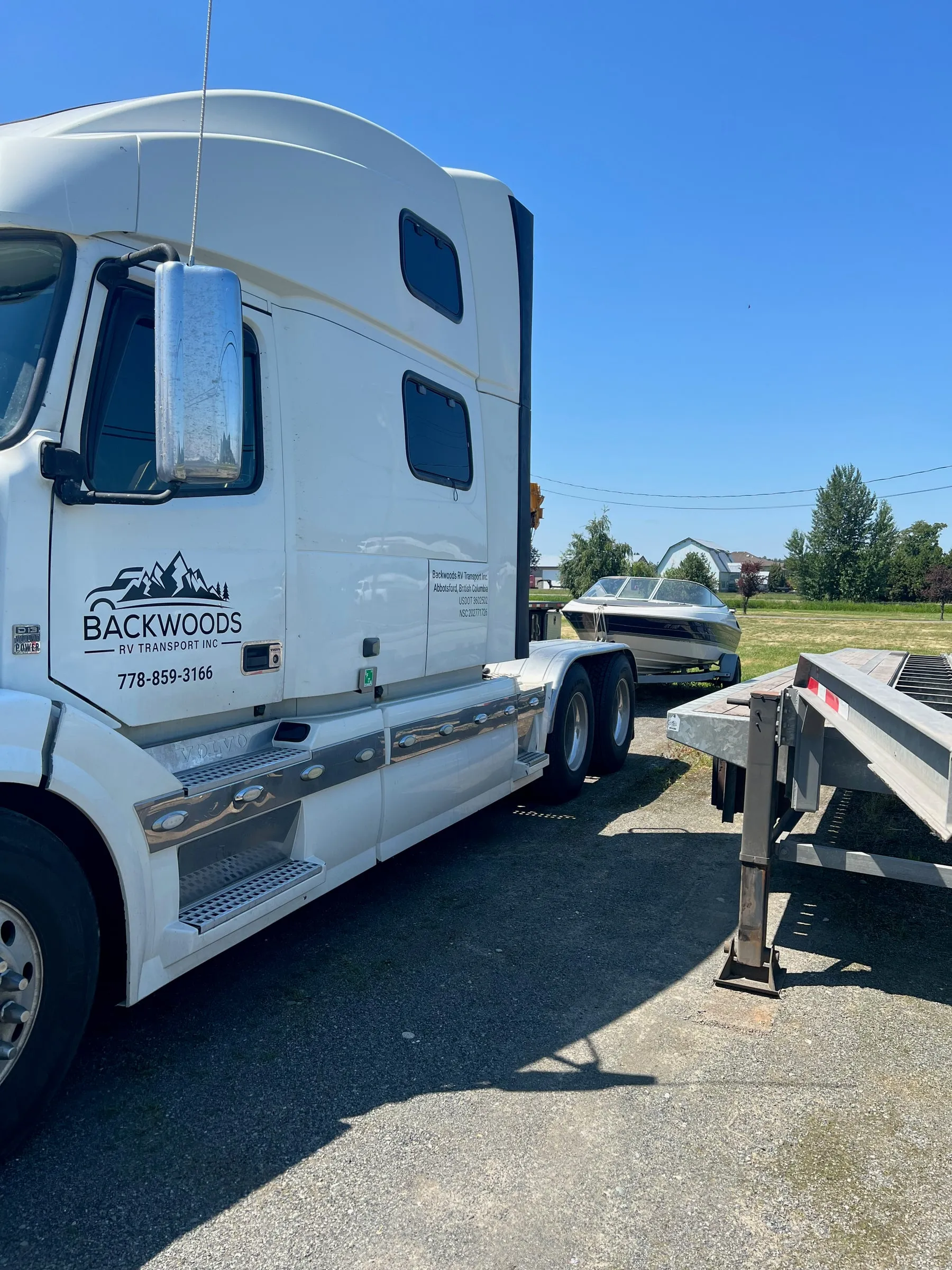 Backwoods semi cab with the company logo and phone number on the door